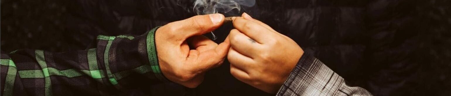 Hands sharing a joint – Bud Board Dispensary in Carlsbad and Hobbs, New Mexico