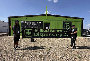 Exterior storefront of Bud Board Dispensary in Hobbs, New Mexico with green signage.