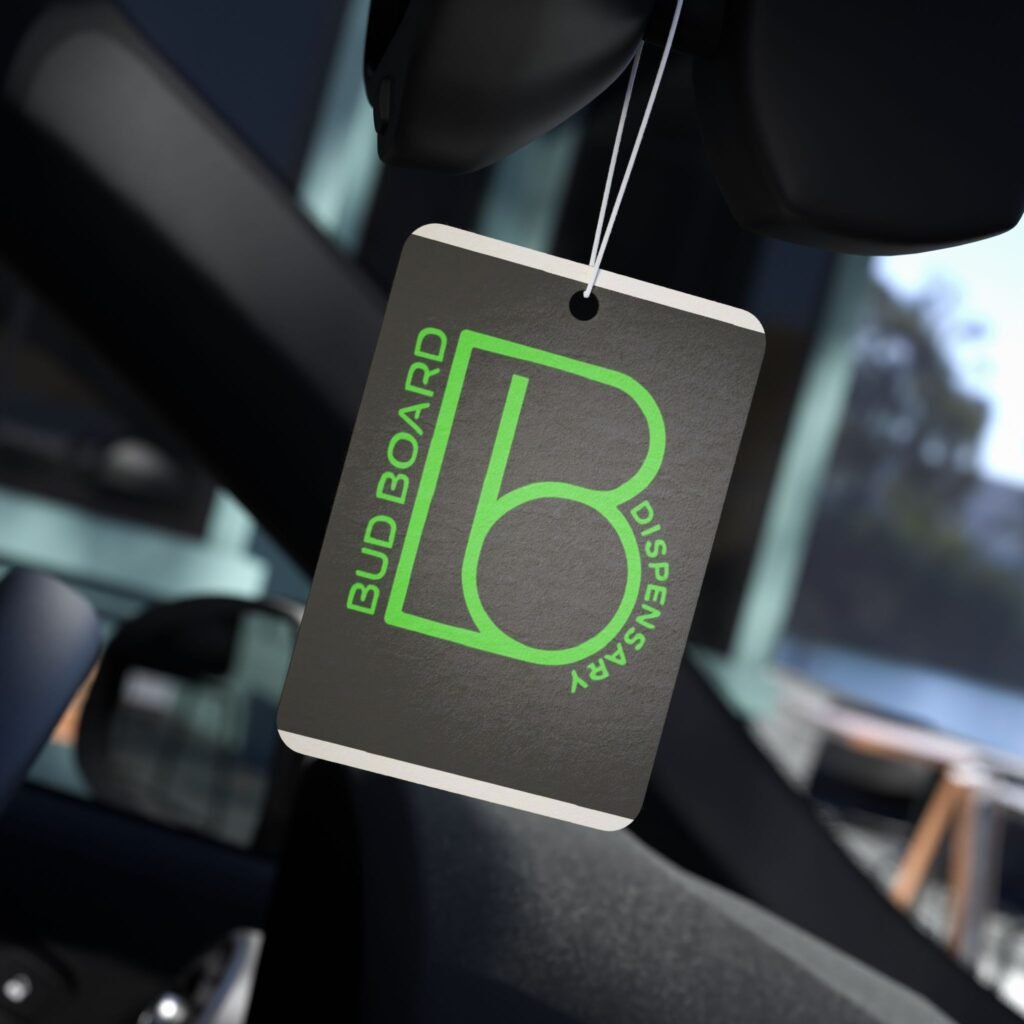 Bud Board Dispensary branded car air freshener hanging from rearview mirror.